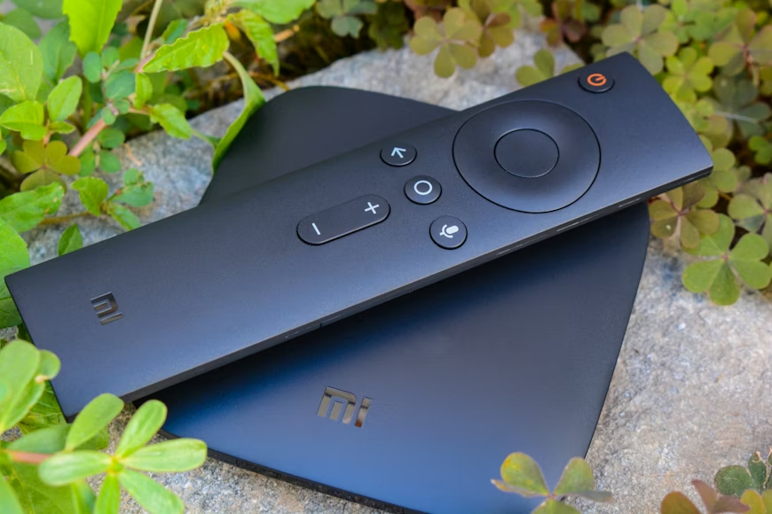 Budget vs premium streaming device setup showing a streaming box and remote for home entertainment.
