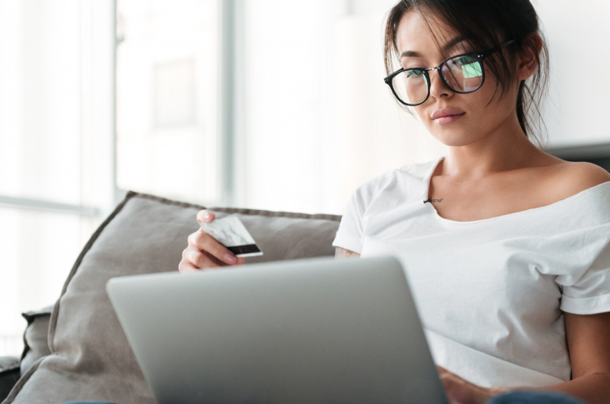 Woman reviewing payment details to stop paying for streaming services they no longer watch.