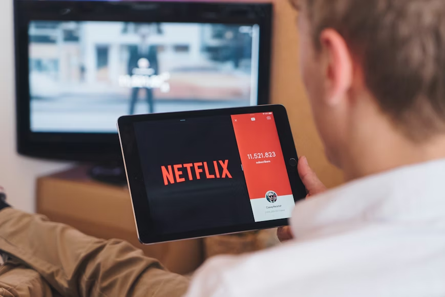 Tablet and TV showing a shared streaming account used to manage household access.