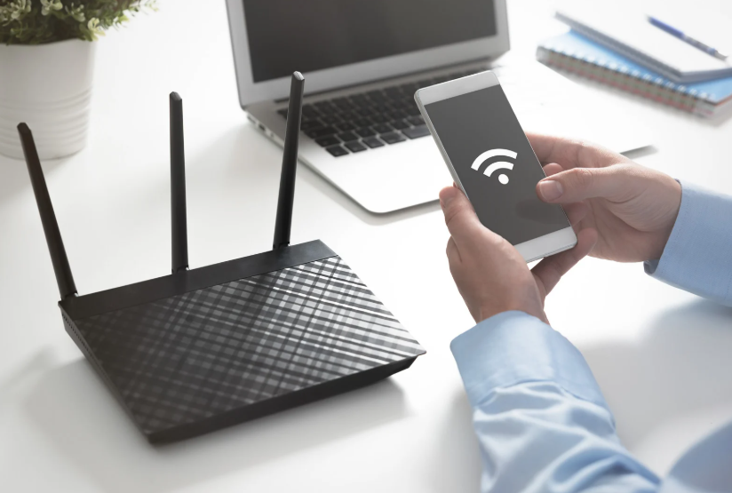 Wi-Fi router and phone showing internet speed for streaming across home devices.