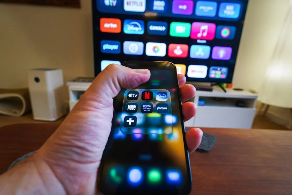 Streaming apps on a phone and TV illustrate how many streaming services is too many for one household.