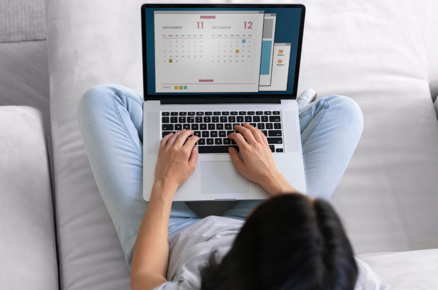 Woman using a calendar on a laptop to plan the subscription rotation method.