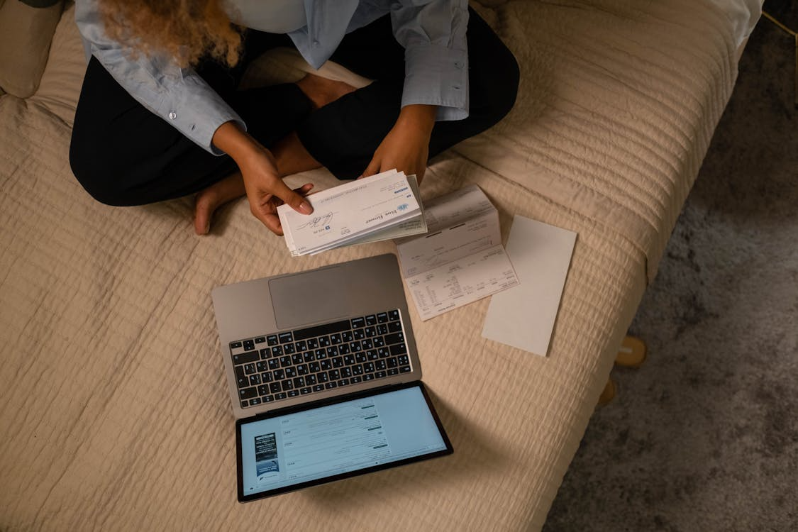 Laptop and household bills showing the real cord cutting cost after canceling cable.