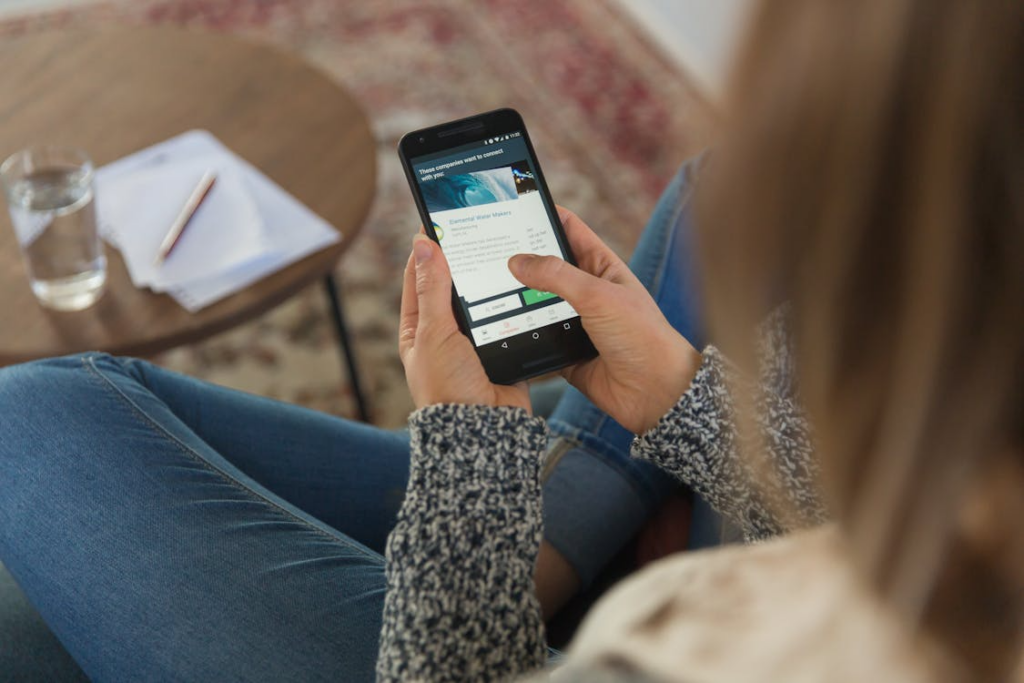 Person reviewing whether to cancel or pause subscriptions on a phone.
